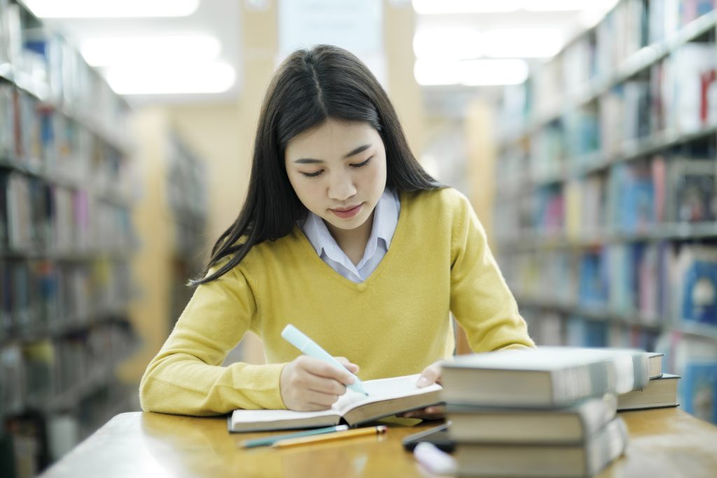 Student studying at library.